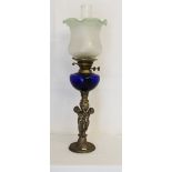 A tall brass based twin wicked oil lamp with chimney & shade