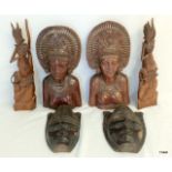 Three pairs of carved figures depicting godesses and masks