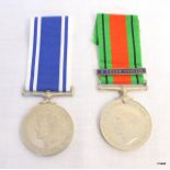 A WW2 Defence Medal with a 3 Years Service bar and a named George VI Police Long Service Medal to