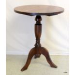 A mahogany coloured circular lamp table