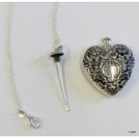A silver heart shaped perfume bottle on silver chain
