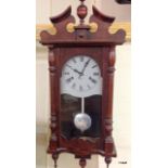 A mahogany wall clock