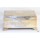 A hallmarked silver cigarette box 14cm x 9cm x 6cm on bracket feet engraved JSE from Officers NCOs &