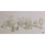 A quantity of crystal cut glass vases, a sugar shaker, knife rests and pots