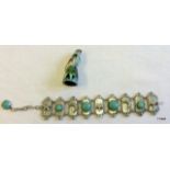 An Oriental silver and turquoise bracelet and a cloisonne enamel bird thimble