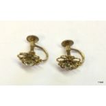 A pair of gold screw back diamond stud earrings 0.2ct each