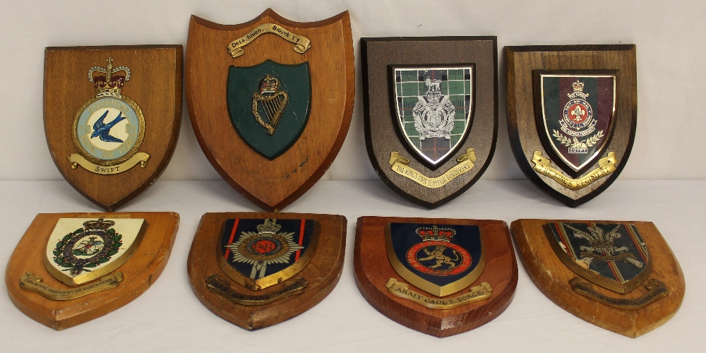 Eight military badges mounted on wooden shields to the Kings Regiment - Regiment of Fusiliers -