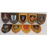 Nine military badges mounted on wooden shields to the Devon & Dorset Regiment - Royal Regiment of