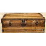 A wooden banded travelling trunk 110 x 55 x 35cm
