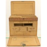 Well carved fall front oak stationary box with lift lid opening to reveal numerous drawers and