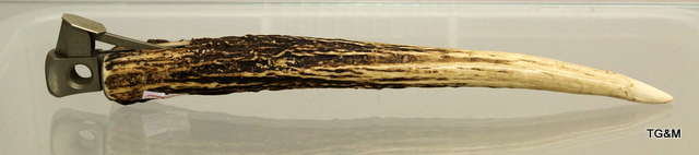 An antler carved cigar cutter