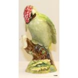 A Beswick figure of a Woodpecker No. 1218, measuring 22cm high
There is damage on the rear of the