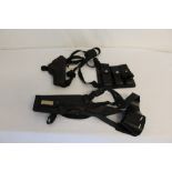 Two leather shoulder holsters one with a triple magazine pouch