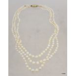 Triple strand graduated pearl necklace with foliate engraved gold barrel clasp approximately 44cm