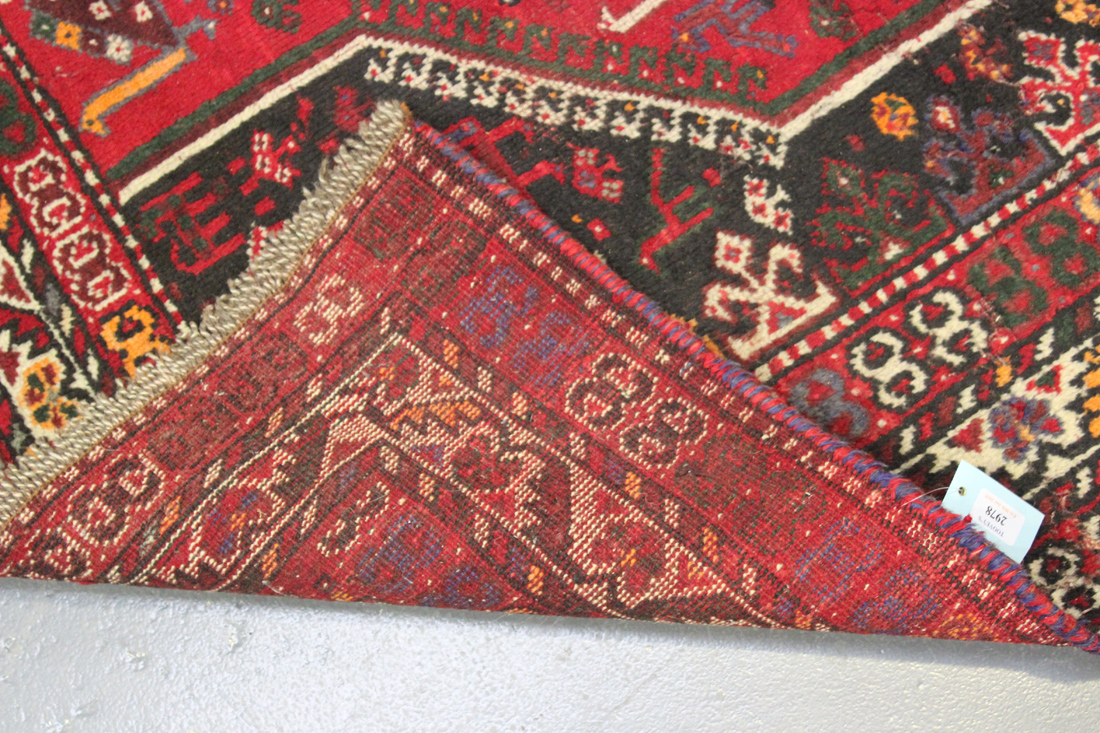 A Shiraz carpet, South-west Persia, early 20th Century, the red field with three linked medallions - Image 2 of 2