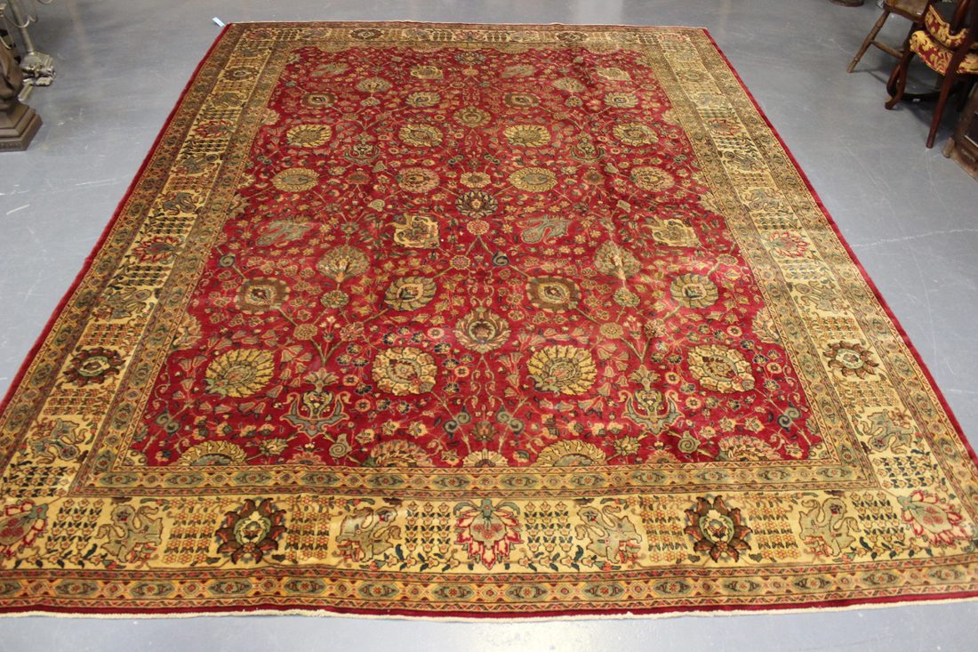A Tabriz carpet, Central Persia, mid-20th Century, the red field with overall palmettes and