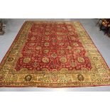 A Tabriz carpet, Central Persia, mid-20th Century, the red field with overall palmettes and