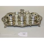 A George III silver inkstand of rectangular form with piecrust, scallop shell and scroll rim, fitted