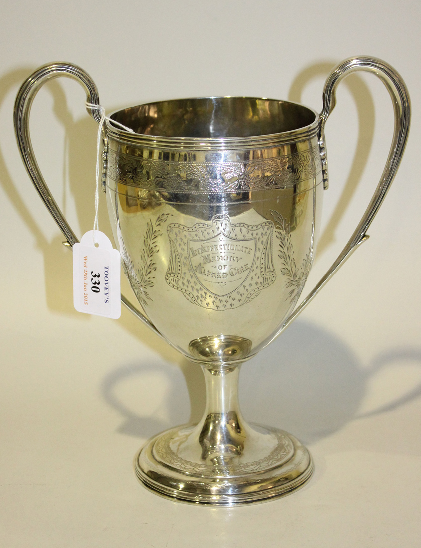 A George III silver two handled cup, the ovoid body engraved with simulated fabric cartouches and
