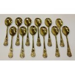 A set of twelve late Victorian silver gilt dessert/sundae spoons, each with rococo scroll