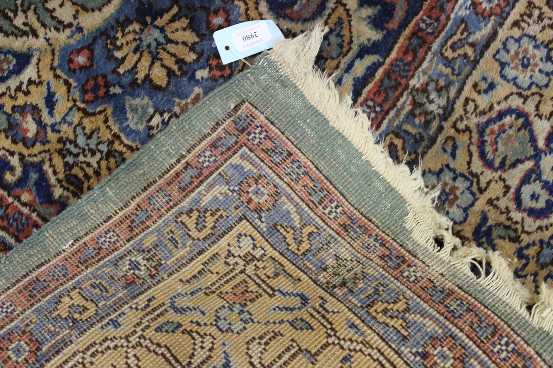An Indian carpet, mid-20th Century, the green field with a lobed medallion, within an ivory palmette - Image 2 of 2