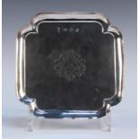 A George II silver card salver of square form with incurved corners and conforming bracket feet, the