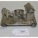 A Chinese silver toy, modelled as a farmer, ox, shed and oval coopered trough on a rectangular