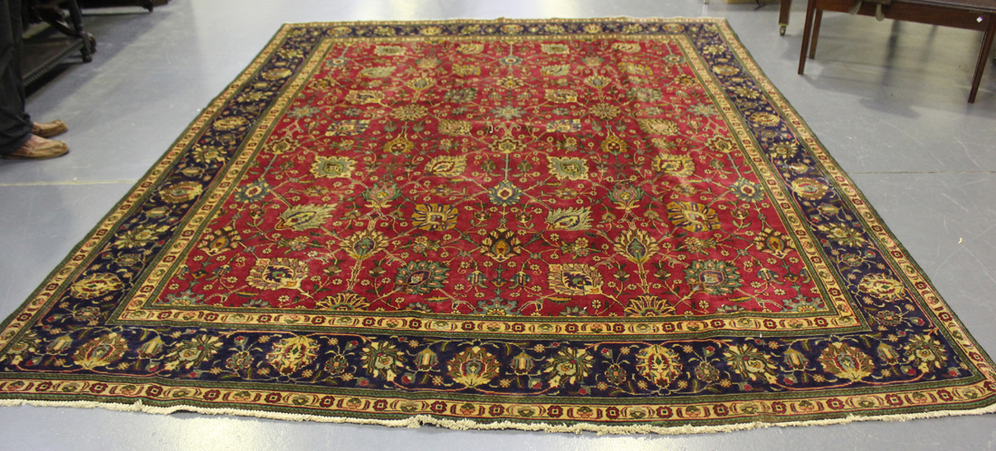 A Tabriz carpet, Central Persia, mid-20th Century, the claret field with overall palmettes and