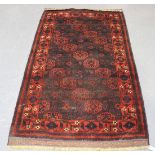 A Beluche rug, Afghan/Persian borders, early 20th Century, the red and aubergine field with