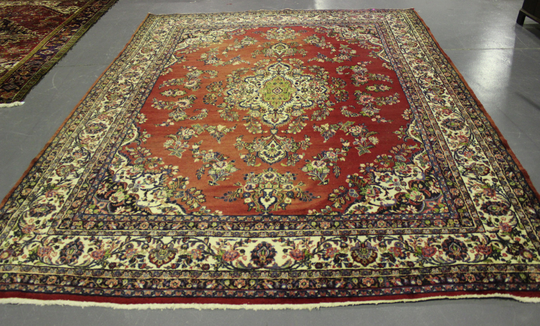 A Kashan carpet, Central Persia, mid-20th Century, the red field with a foliate medallion supporting