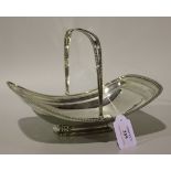 A George III silver bread basket with gadrooned swing handle and rim, on a rectangular foot,