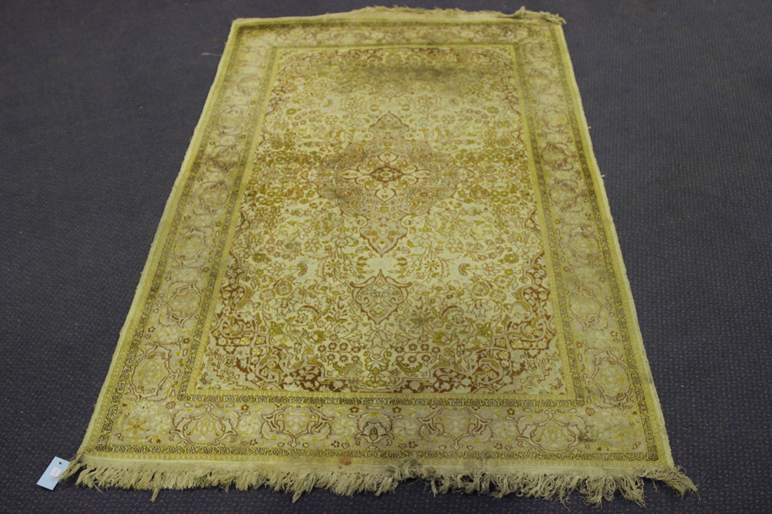 A Kashmir art silk rug, late 20th Century, the lobed medallion supported by scrolling vines,