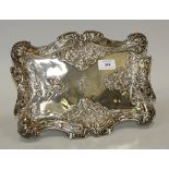 An Art Nouveau silver shaped rectangular dressing table tray, embossed with maidens' masks with