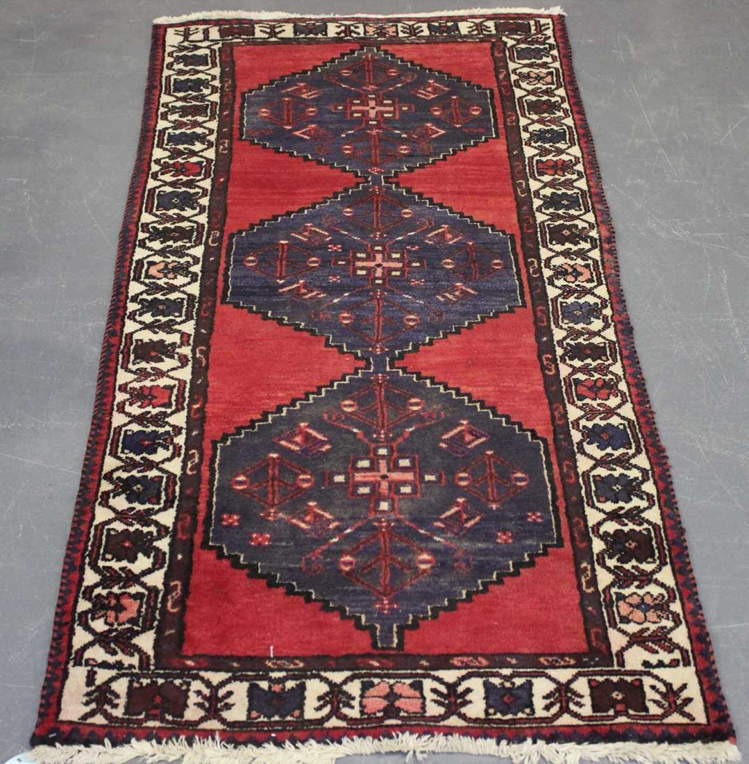 A Hamadan rug, North-west Persia, mid-20th Century, the red field with three stepped reserves,