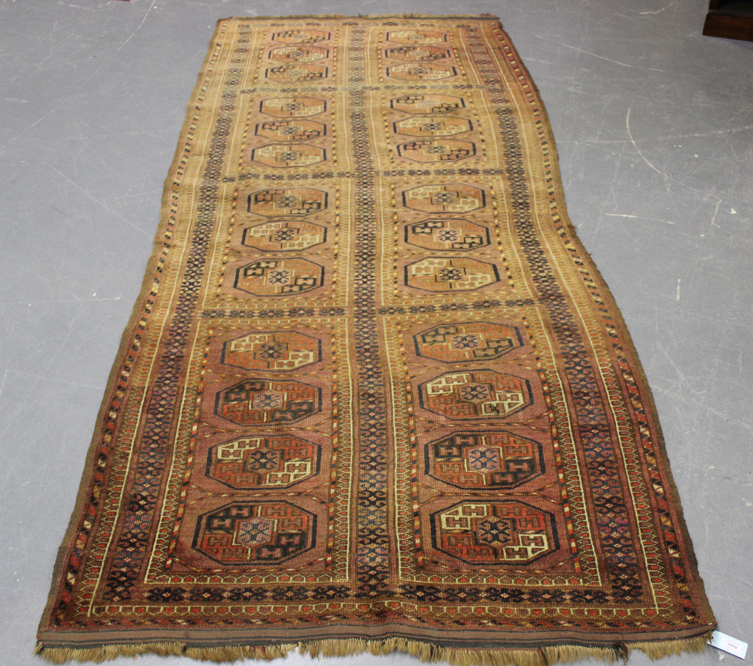 A Tekke runner, West Turkestan, early 20th Century, the plum field with two columns of guls,