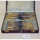 A set of twelve late 19th Century horn handled table and dessert knives, each blade inscribed '