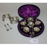A set of six Victorian silver salts of circular form with wavy rims and six matching salt spoons,