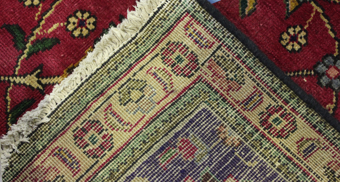 A Tabriz carpet, Central Persia, mid-20th Century, the claret field with overall palmettes and - Image 2 of 2