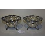 A pair of Dutch silver circular bonbon baskets, each pierced lattice and floral engraved outswept