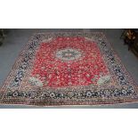 A Najafabad carpet, Central Persia, mid-20th Century, the red field with a flowerhead and palmette
