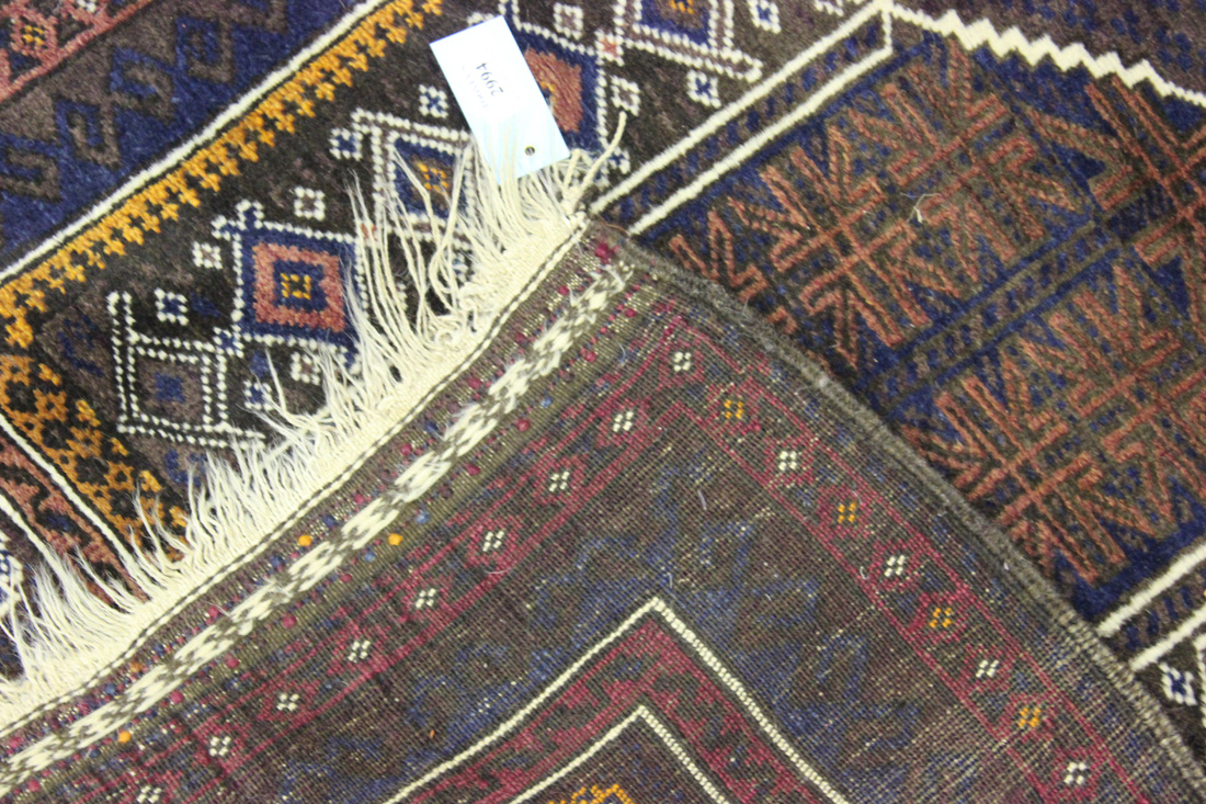 An Afghan Beluche prayer rug, early 20th Century, the ink blue mihrab filled with star motifs, - Image 2 of 2