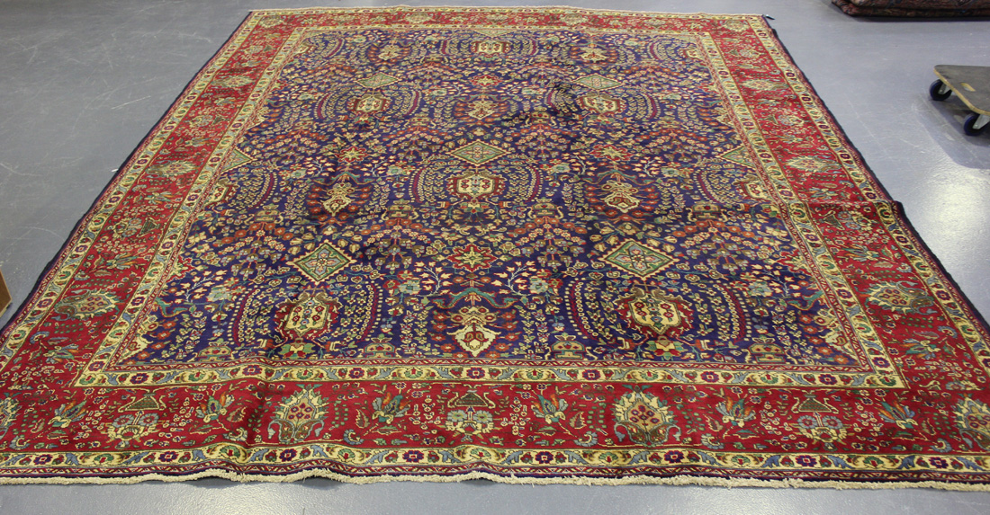 A Tabriz carpet, Central Persia, mid-20th Century, the ink blue field with overall palmettes and