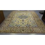 A Central Persian carpet, mid/late 20th Century, the ivory field with a blue flowerhead medallion,