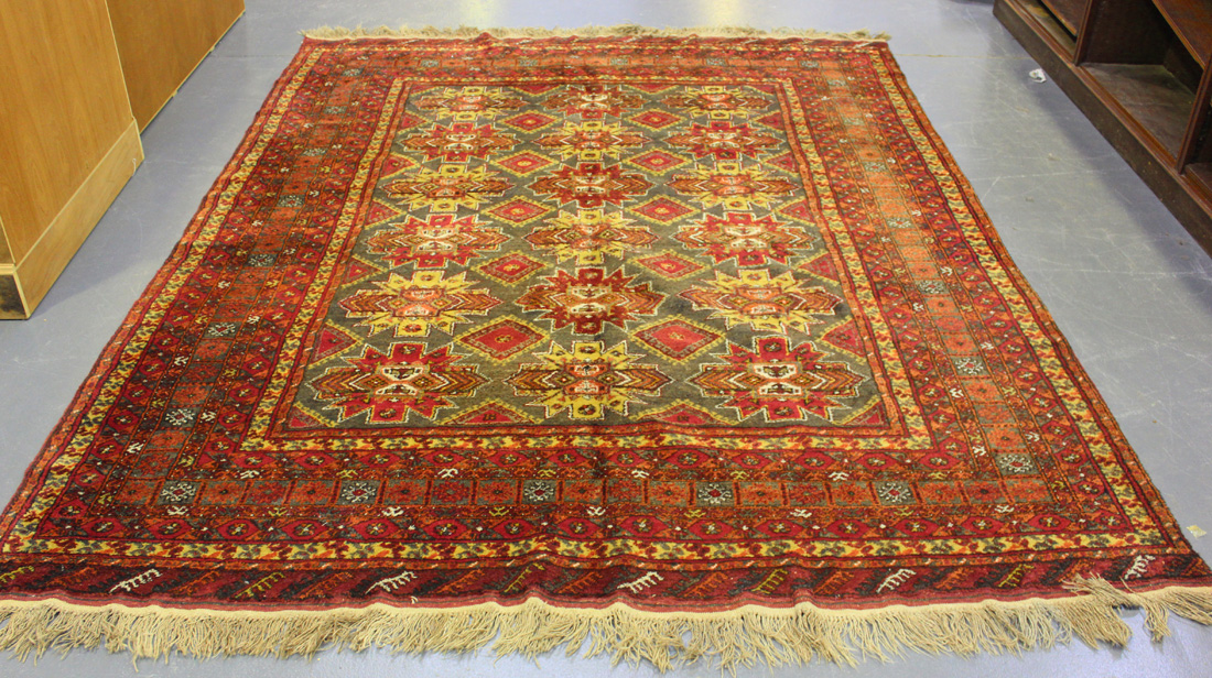 An Afghan carpet, mid/late 20th Century, the mushroom coloured field with overall star medallion,