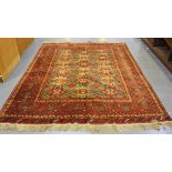 An Afghan carpet, mid/late 20th Century, the mushroom coloured field with overall star medallion,