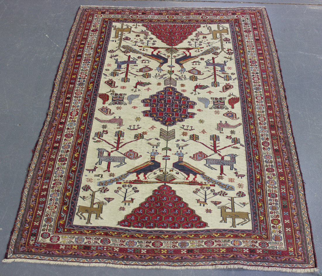 An Afshar flatweave rug, late 20th Century, the ivory field with a central medallion supported by