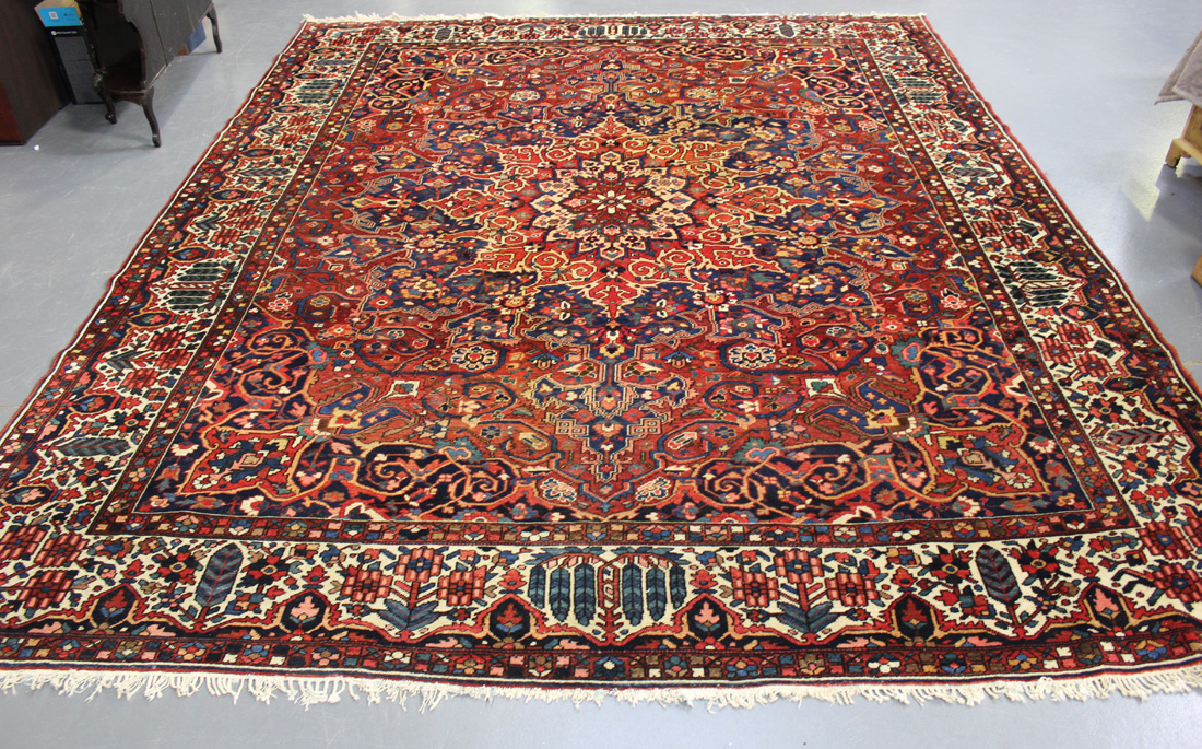 A Bakhtiari carpet, North-west Persia, mid-20th Century, the terracotta field with a flowerhead