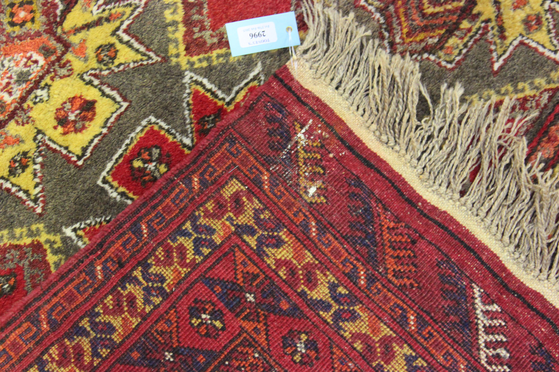 An Afghan carpet, mid/late 20th Century, the mushroom coloured field with overall star medallion, - Image 2 of 2