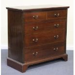 An Edwardian mahogany chest of two short and three long drawers with crossbanded borders, raised