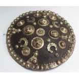 A circular hide dhal with four brass bosses and domed stud decoration, diameter approx 34cm.